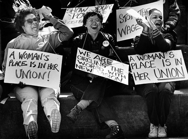 women carrying placards saying "A woman's place is in her union" and other messages