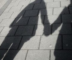 Shadow of two people holding hands, representing solidarity